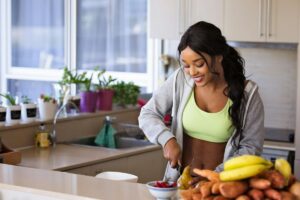 Woman preparing healthy food after a workout.
