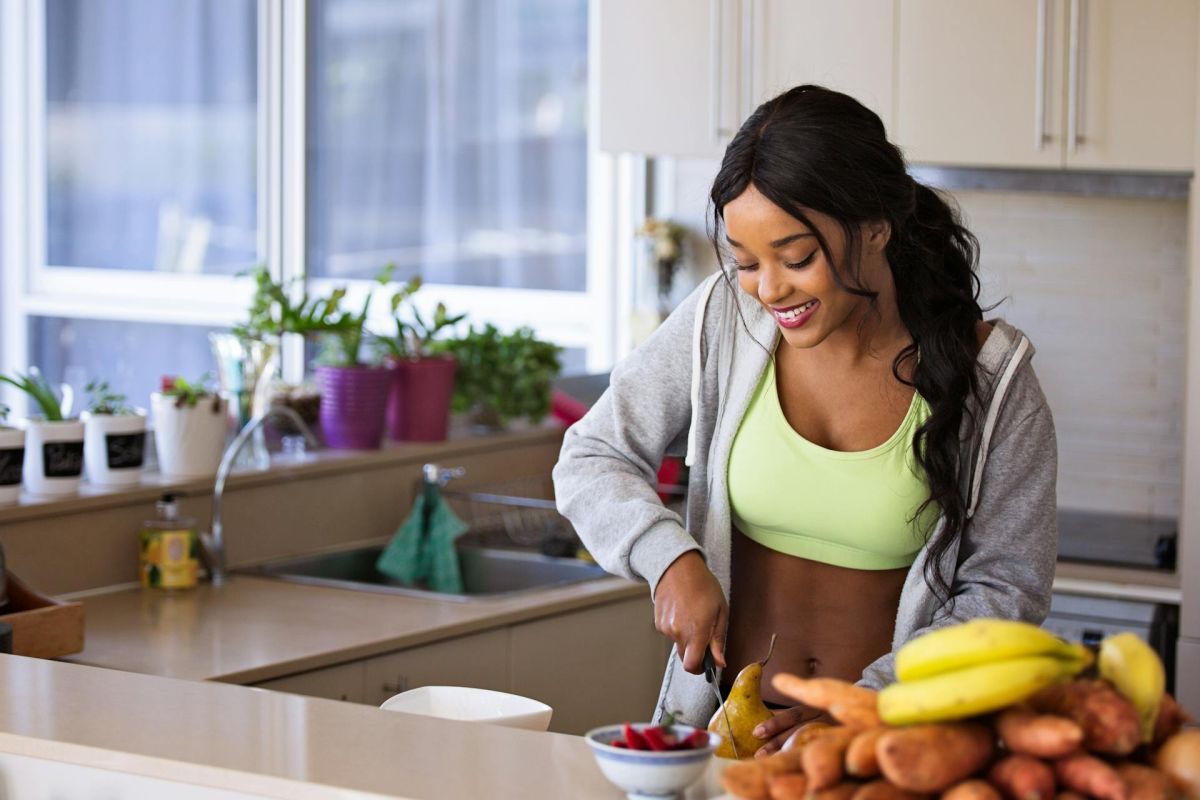 Woman preparing healthy food after a workout.