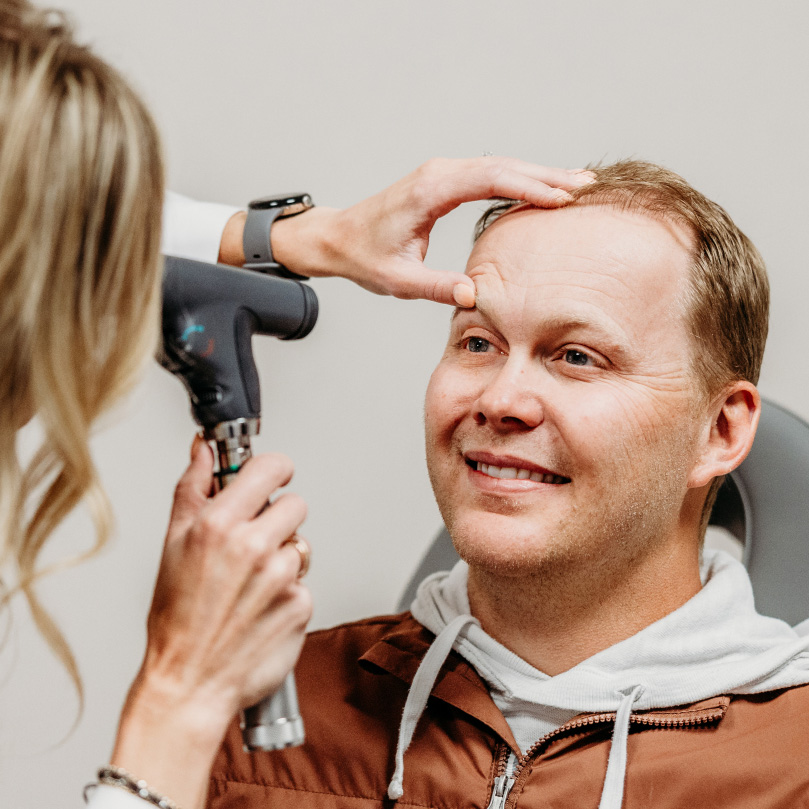 Headache clinic provider in West Fargo performing a neurological assessment for migraine care