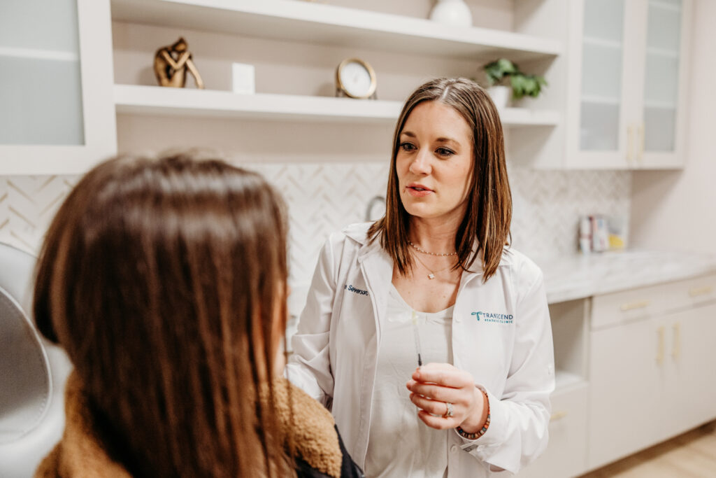 Transcend Headache Clinic provider explaining a treatment option to a female patient during a one-on-one consultation.
