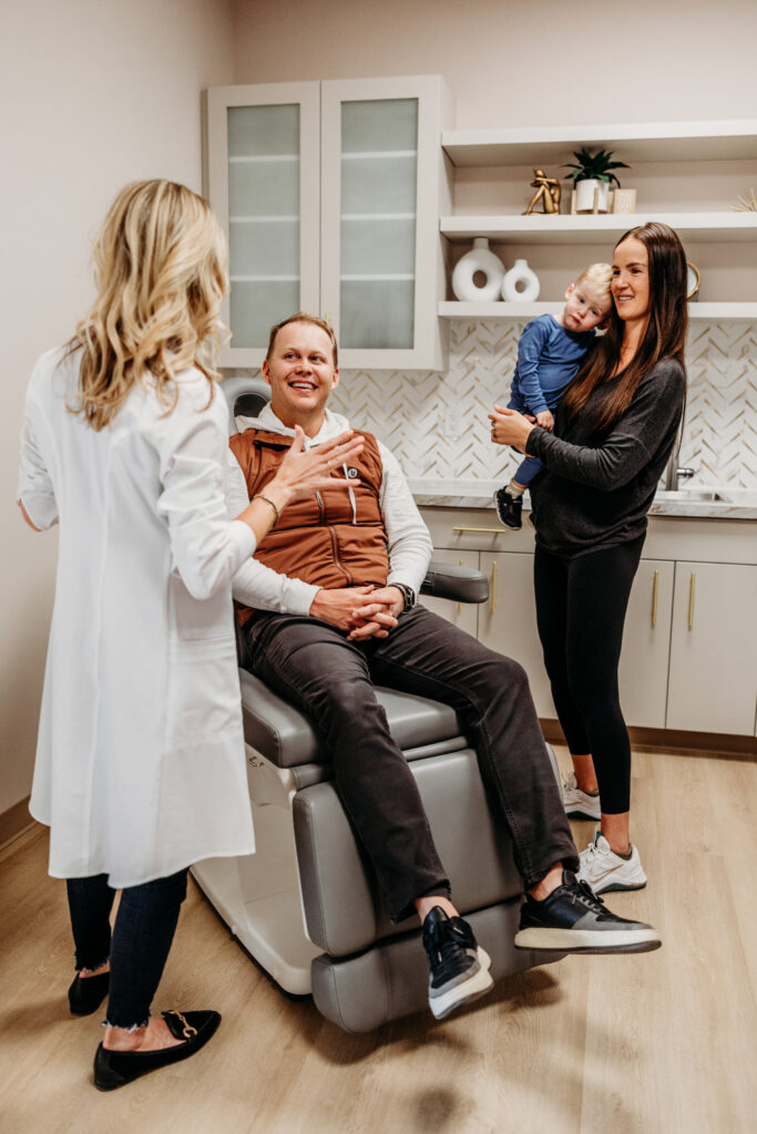 Headache specialist at Transcend Headache Clinic in West Fargo discussing a care plan with a patient and his family.