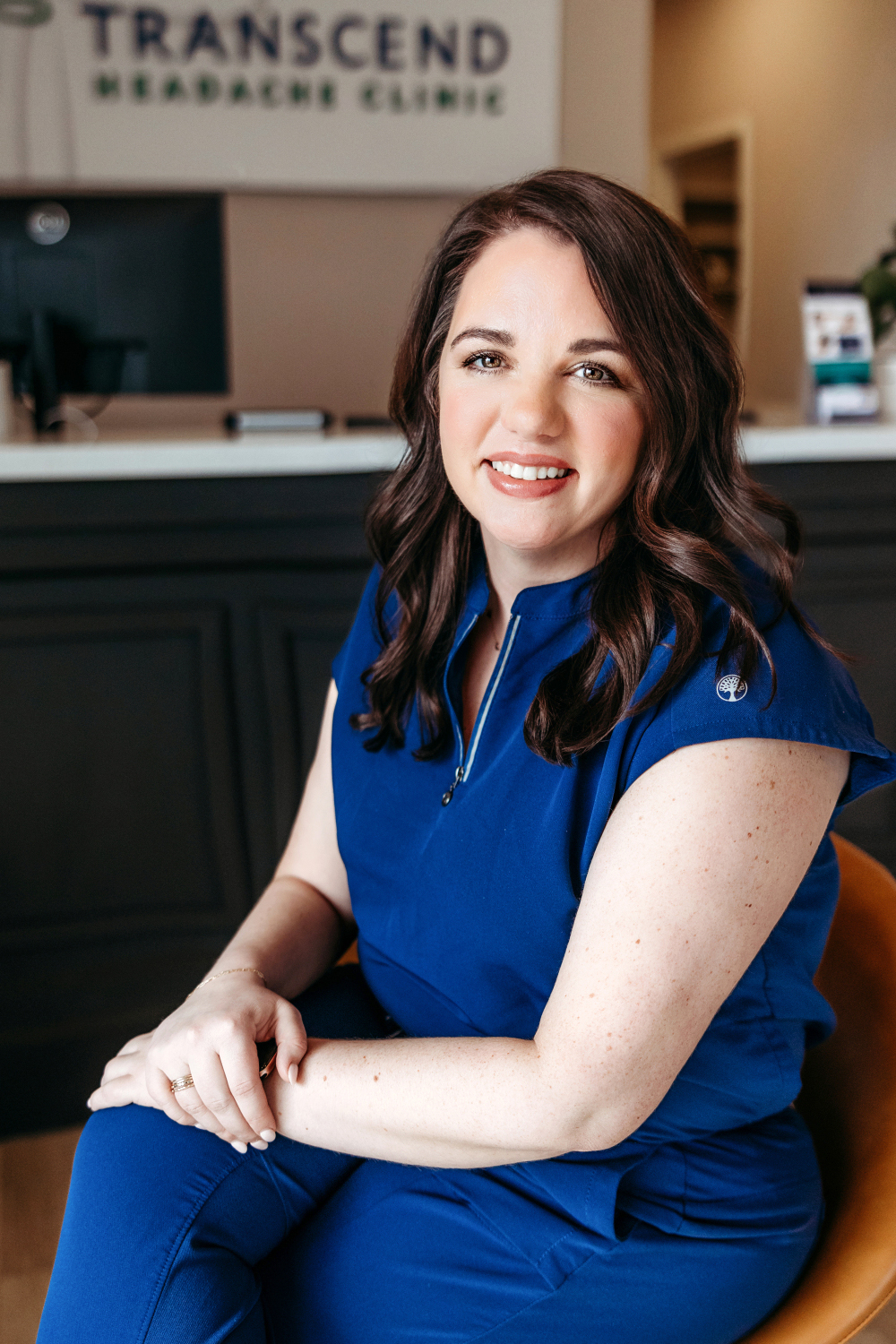 Emily Haen, RN, Clinical Nurse Manager at Transcend Headache Clinic, seated and smiling.