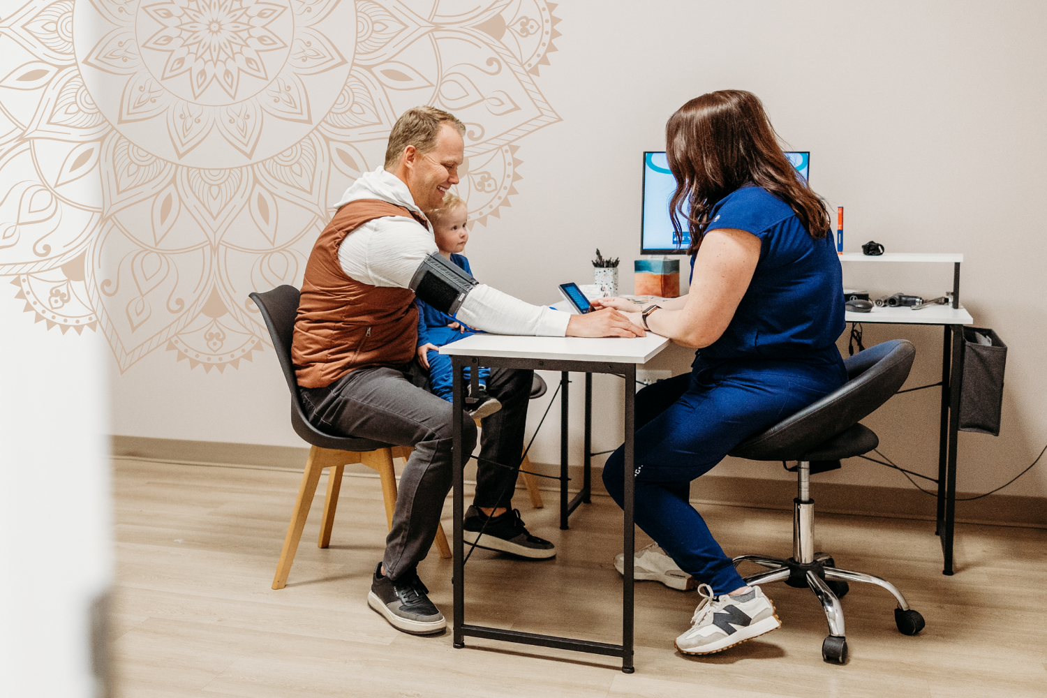 Migraine specialist in West Fargo meeting with a patient and child during a consultation at Transcend Headache Clinic.