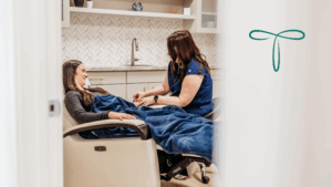 Nurse administering vitamin IV infusion to a patient at Transcend Headache Clinic