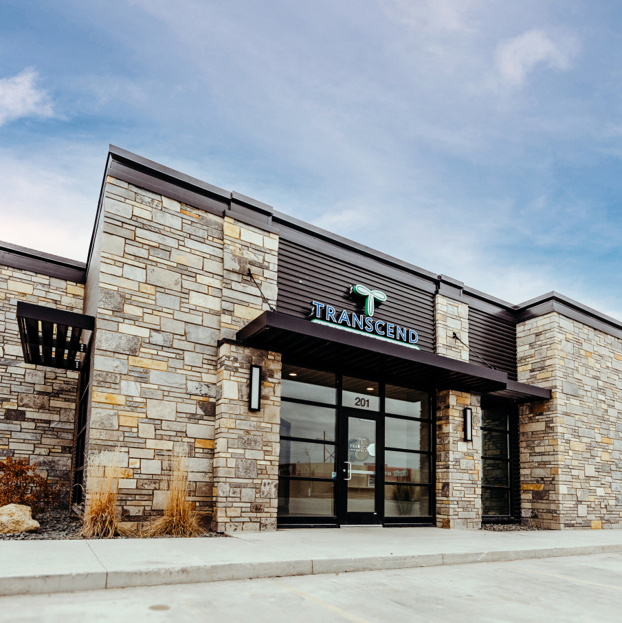 Exterior of Transcend Headache Clinic in West Fargo, North Dakota, featuring modern stone and glass architecture.