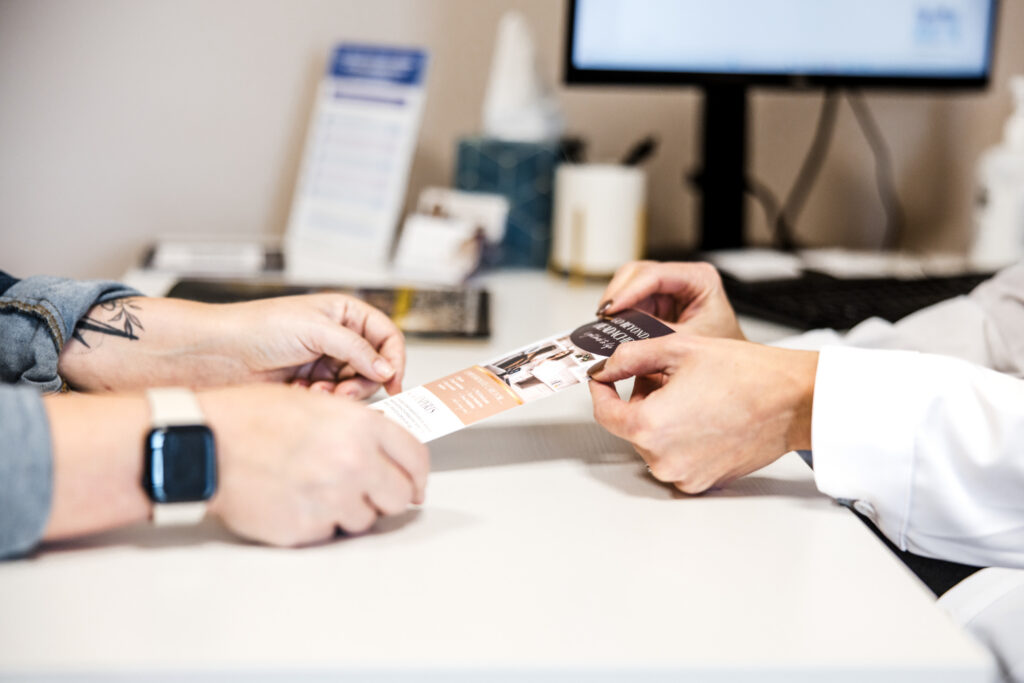 Provider sharing migraine treatment information with patient at Transcend Headache Clinic.