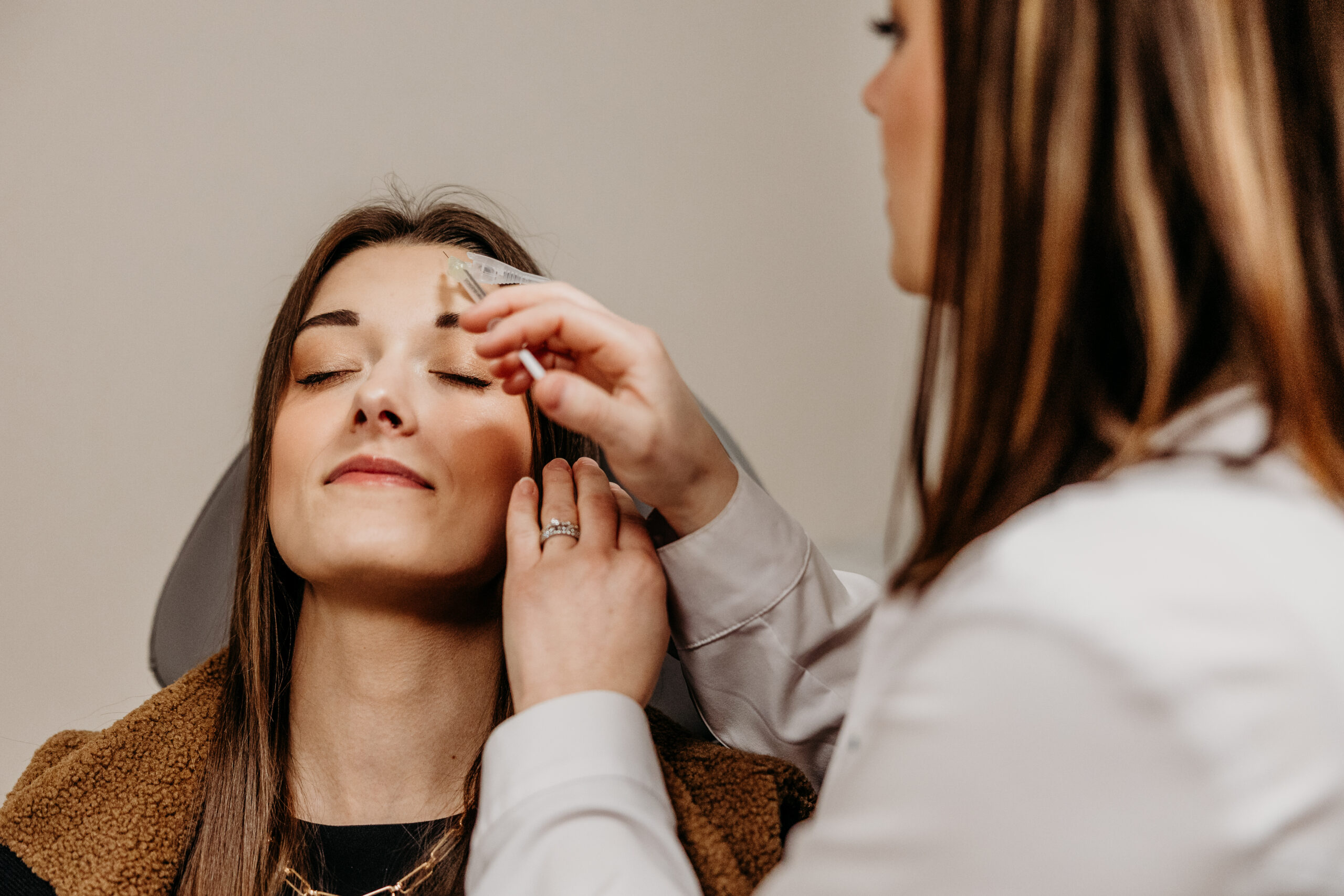 Botox injection for migraines being administered to forehead during preventative treatment.