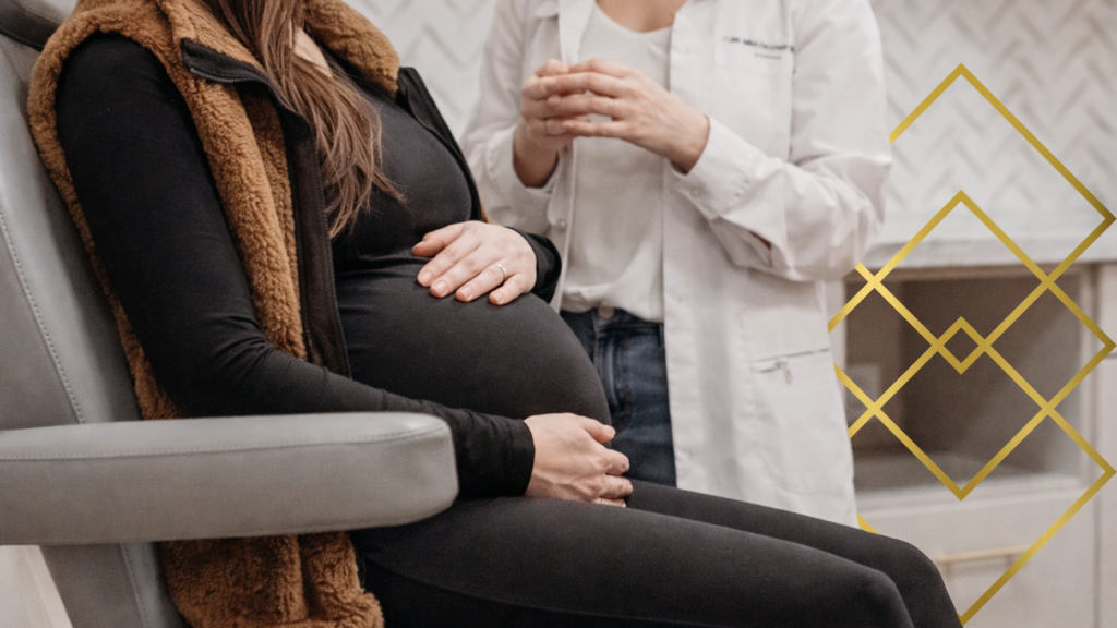 Pregnant patient sitting in clinic chair discussing headache treatment with provider.