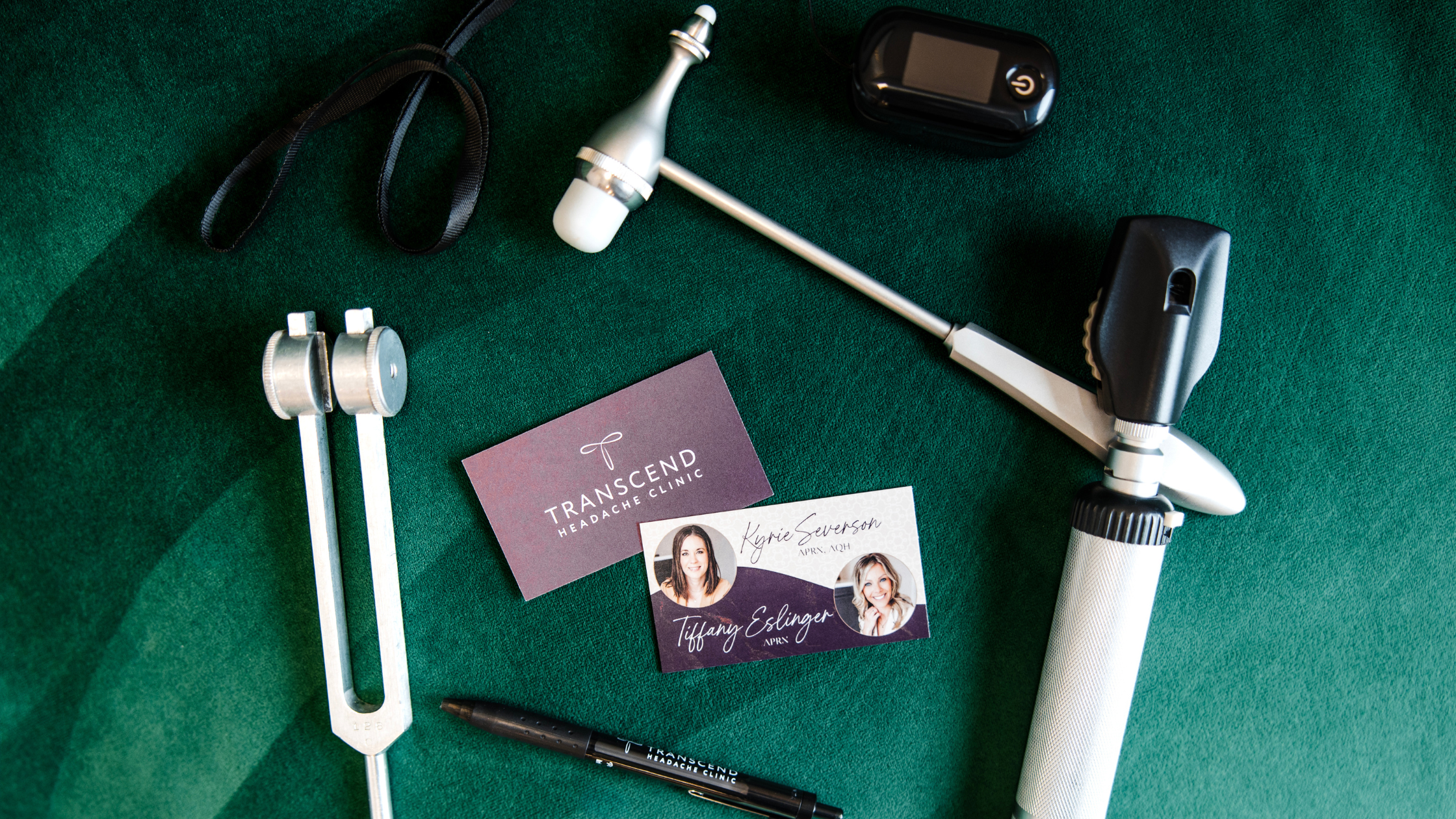Neurological exam tools and Transcend Headache Clinic materials on velvet green surface.