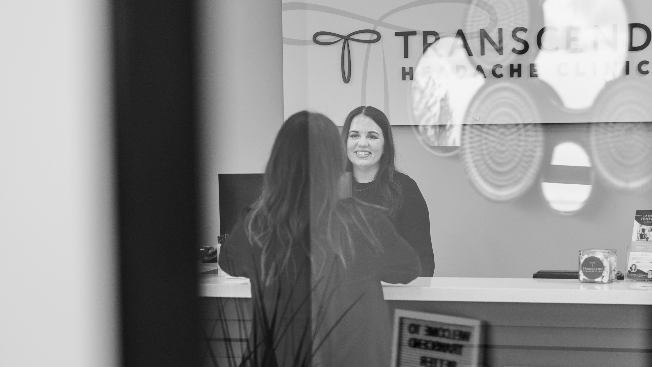 Patient checking in at Transcend Headache Clinic front desk in Fargo, ND.