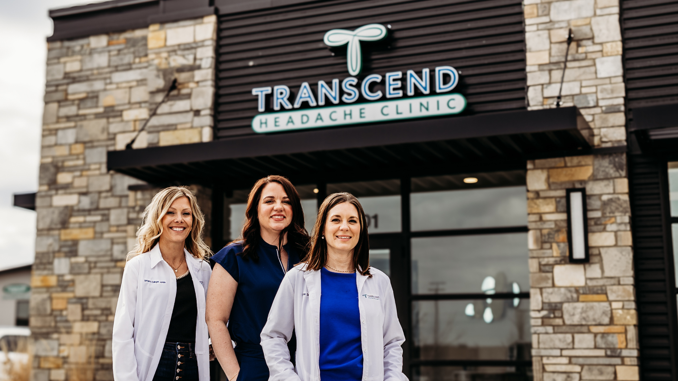 Headache specialists standing outside Transcend Headache Clinic in West Fargo, ND.